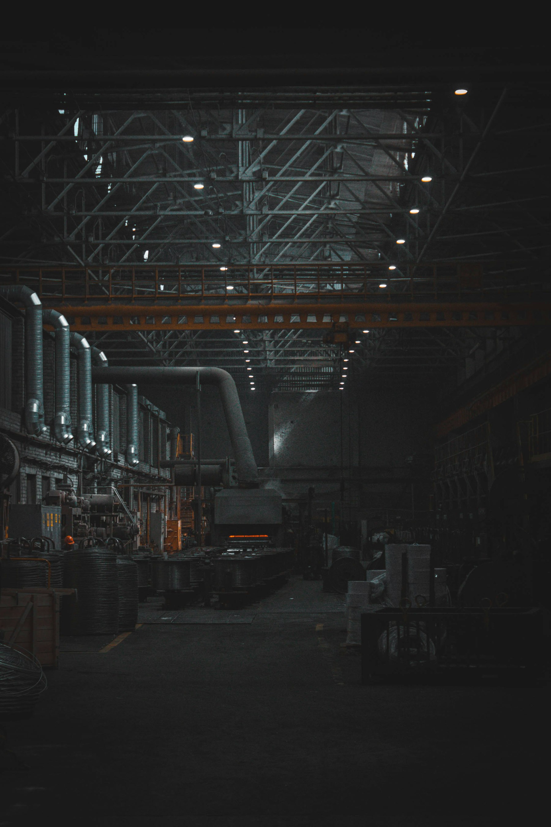A dark machine hall with lit CNC equipment